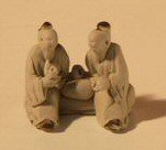 Two Men Sitting Ceramic Figurine