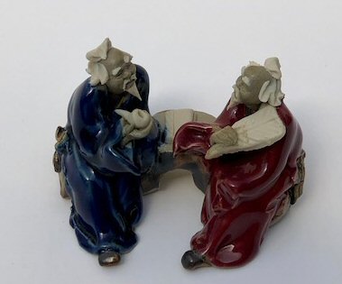 Ceramic Figurine<br>Two Men Sitting On A Bench<br>Color: Red & Blue